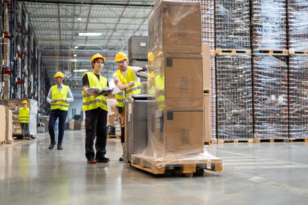 Employees consult while working in the warehouse.jpg